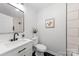 Modern bathroom featuring sleek vanity, black fixtures, and stylish black and white tile floors at 4913 Seacroft Rd, Charlotte, NC 28210