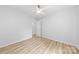 Spacious bedroom with hardwood floors, a ceiling fan, and an open door at 4913 Seacroft Rd, Charlotte, NC 28210
