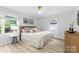 Bright bedroom with natural light from large windows, hardwood floors, and neutral decor at 4913 Seacroft Rd, Charlotte, NC 28210