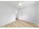 A cozy bedroom featuring hardwood floors, closet space, and neutral walls at 4913 Seacroft Rd, Charlotte, NC 28210