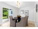 Inviting dining area featuring a modern light fixture and sliding glass door to the backyard at 4913 Seacroft Rd, Charlotte, NC 28210