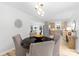 Dining room with modern light fixture, hardwood floors, and views of the kitchen and living spaces at 4913 Seacroft Rd, Charlotte, NC 28210