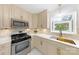 Stylish kitchen with quartz countertops, stainless steel appliances, and custom cabinetry at 4913 Seacroft Rd, Charlotte, NC 28210