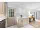 Bright kitchen featuring an island with storage and countertops, backsplash, and exterior access at 4913 Seacroft Rd, Charlotte, NC 28210
