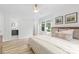 Spacious main bedroom featuring hardwood floors, a ceiling fan, and ensuite bathroom at 4913 Seacroft Rd, Charlotte, NC 28210