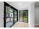 Bright sunroom with large windows and hardwood floors, offering great views of the backyard at 4913 Seacroft Rd, Charlotte, NC 28210