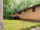 Large backyard featuring a deck and mature trees, perfect for outdoor activities at 5109 Goldcrest Dr, Indian Trail, NC 28079