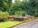 Brick fenced backyard with lush landscaping around the pool, creating a serene retreat at 5109 Goldcrest Dr, Indian Trail, NC 28079