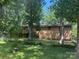 Backyard view showcasing the house's exterior, mature trees, and lush greenery at 5109 Goldcrest Dr, Indian Trail, NC 28079