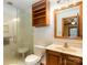 Bathroom with a glass-enclosed shower, toilet, and wooden vanity at 5109 Goldcrest Dr, Indian Trail, NC 28079