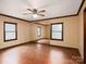 Bright bedroom featuring hardwood floors, large windows, and a mirrored wall at 5109 Goldcrest Dr, Indian Trail, NC 28079