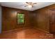 Charming bedroom with wood-paneled walls, window view, and hardwood floors at 5109 Goldcrest Dr, Indian Trail, NC 28079