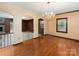 Elegant dining area with hardwood floors and decorative chandelier, perfect for formal gatherings at 5109 Goldcrest Dr, Indian Trail, NC 28079