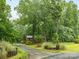 Long paved driveway flanked by brick and landscaping leads to home at 5109 Goldcrest Dr, Indian Trail, NC 28079