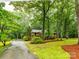 Scenic view of home and tree-lined driveway, enhancing the property's curb appeal at 5109 Goldcrest Dr, Indian Trail, NC 28079