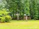 The home is brick with mature trees and manicured lawn at 5109 Goldcrest Dr, Indian Trail, NC 28079