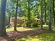 Brick home surrounded by lush trees, offering privacy and a serene natural setting at 5109 Goldcrest Dr, Indian Trail, NC 28079