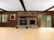 Living room stone fireplace with built-in details, surrounded by wood paneling at 5109 Goldcrest Dr, Indian Trail, NC 28079