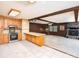 Open floor plan connects the kitchen to the living room featuring wood accents and tile flooring at 5109 Goldcrest Dr, Indian Trail, NC 28079