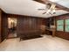 Inviting living room featuring wood-paneled walls, built-in shelving, and a view to the hall at 5109 Goldcrest Dr, Indian Trail, NC 28079