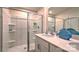 Clean bathroom featuring a shower, white cabinets, quartz countertops and a large mirror at 5137 Hyrule Dr, Charlotte, NC 28262