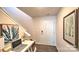Inviting entryway featuring hardwood floors, neutral paint, and modern decor, plus space for a home office setup under the stairs at 5137 Hyrule Dr, Charlotte, NC 28262