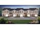 Attractive townhome exteriors with neutral siding, brick accents, garages, and manicured lawns at 5137 Hyrule Dr, Charlotte, NC 28262