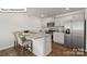 Well-equipped kitchen boasts stainless steel appliances, granite countertops, and a breakfast bar with seating at 5137 Hyrule Dr, Charlotte, NC 28262
