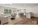 Inviting living space featuring a cozy seating area, contemporary decor, and natural light from a large window at 5137 Hyrule Dr, Charlotte, NC 28262