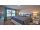 Cozy bedroom featuring a comfortable bed, soft lighting, neutral paint, and large window at 5137 Hyrule Dr, Charlotte, NC 28262