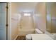 Bright bathroom with a soaking tub, neutral tile, and a window for natural light at 5436 Scarlet Sage Dr, Charlotte, NC 28215