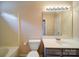 Clean bathroom with a shower-tub combo, white toilet, and modern vanity with ample lighting at 5436 Scarlet Sage Dr, Charlotte, NC 28215
