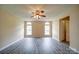 Bright bedroom with modern flooring, neutral walls, a ceiling fan, and many windows at 5436 Scarlet Sage Dr, Charlotte, NC 28215