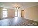 Spacious bedroom with new flooring, neutral walls, a ceiling fan, and plenty of natural light at 5436 Scarlet Sage Dr, Charlotte, NC 28215