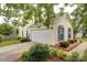 Charming home featuring yellow siding, a two-car garage and meticulously maintained landscaping at 5436 Scarlet Sage Dr, Charlotte, NC 28215