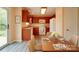 Well-lit kitchen and dining area with wooden cabinets, modern appliances, and sleek flooring at 5436 Scarlet Sage Dr, Charlotte, NC 28215