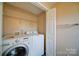 Functional laundry room with washer, dryer, wire shelving, and convenient storage solutions at 5436 Scarlet Sage Dr, Charlotte, NC 28215