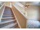 Carpeted staircase with white railings leads to an open-concept living area with high ceilings at 5436 Scarlet Sage Dr, Charlotte, NC 28215