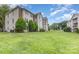 Spacious backyard of multi-Gathering home has a well-maintained lawn and partial view of residences at 6203 Rosecroft Dr, Charlotte, NC 28215