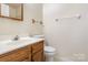 Bathroom with wood vanity and brushed nickel faucet, with shower visible in mirror at 6203 Rosecroft Dr, Charlotte, NC 28215