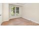 Bright bedroom features wood-look floors and a large window with pleasant view at 6203 Rosecroft Dr, Charlotte, NC 28215