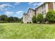 Townhome backyard with well-maintained lawn and mature trees offers a serene and inviting atmosphere at 6203 Rosecroft Dr, Charlotte, NC 28215