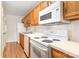Well-lit kitchen featuring white appliances and classic wooden cabinets at 6203 Rosecroft Dr, Charlotte, NC 28215