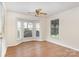 Bright living room with hardwood floors, white walls and large windows at 6203 Rosecroft Dr, Charlotte, NC 28215