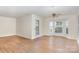 Spacious living room featuring hardwood floors, bright walls and a ceiling fan at 6203 Rosecroft Dr, Charlotte, NC 28215
