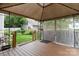 Covered patio with views of the backyard, white picket fence and greenery at 6303 Trevor Simpson Dr, Indian Trail, NC 28079