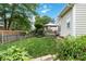 A backyard features lush green grass, landscaping and a small patio at 6303 Trevor Simpson Dr, Indian Trail, NC 28079