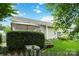 View of backyard with manicured landscaping and a covered patio at 6303 Trevor Simpson Dr, Indian Trail, NC 28079