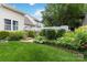 A backyard features lush green grass, landscaping, and a white picket fence at 6303 Trevor Simpson Dr, Indian Trail, NC 28079