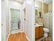 Bright bathroom with wooden cabinets, decorative mirror and a laundry room nearby at 6303 Trevor Simpson Dr, Indian Trail, NC 28079
